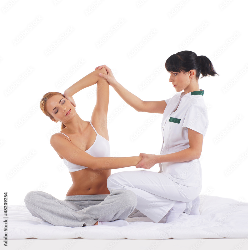 Fototapeta premium A young redhead woman on a Thai massage procedure