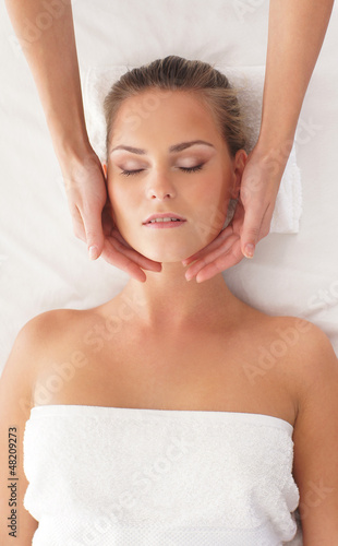 A young woman in a cotton towel on a spa massage