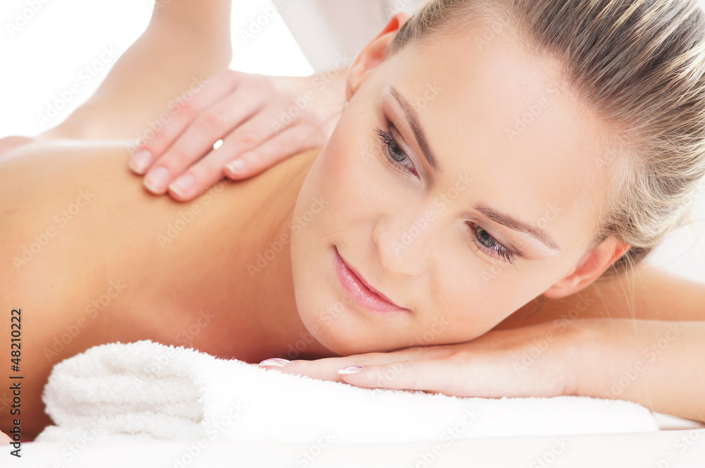 Portrait of a young woman laying on a spa massage