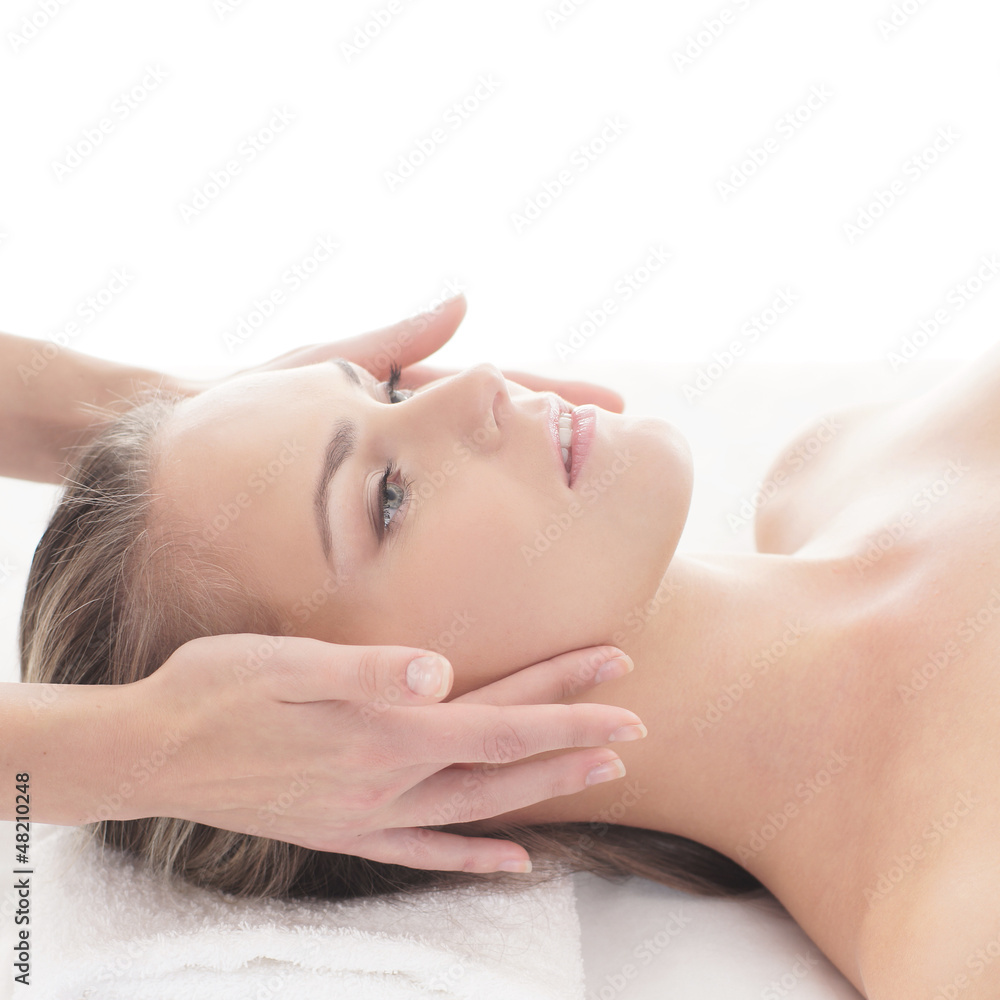Portait of a young woman laying on a spa massage procedure