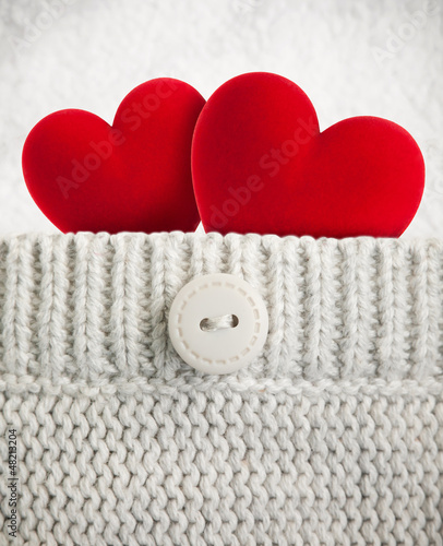 Two red hearts in wool pocket