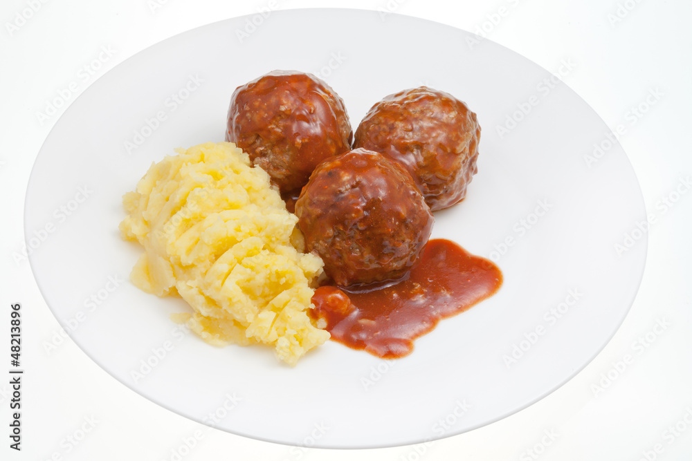 meatballs under meat sauce and mashed potatoes
