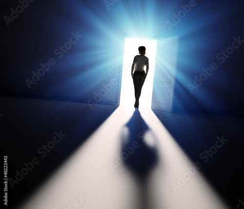 Woman walking into light