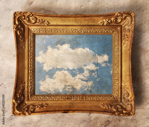Fotografija a vintage photo frame with a cloud in it