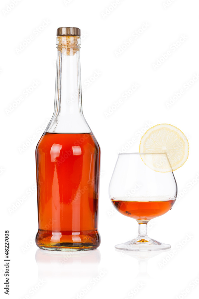 Congac bottle with glass and lime isolated on white Congac bottle with glass and lime isolated on white