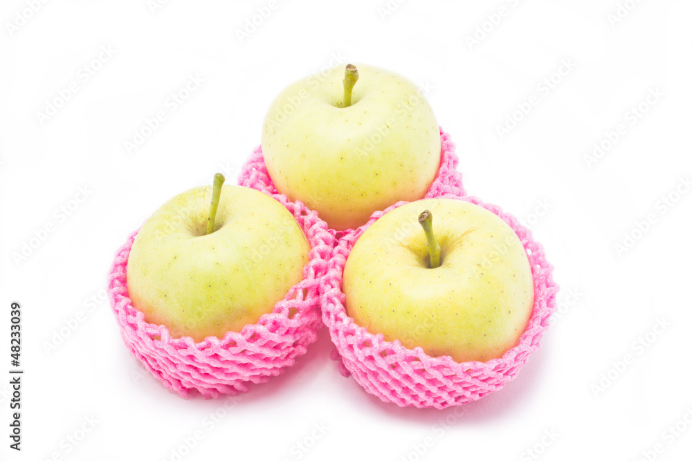 Green apples in red packaging isolated on white background. Green apples in red packaging isolated on white background.