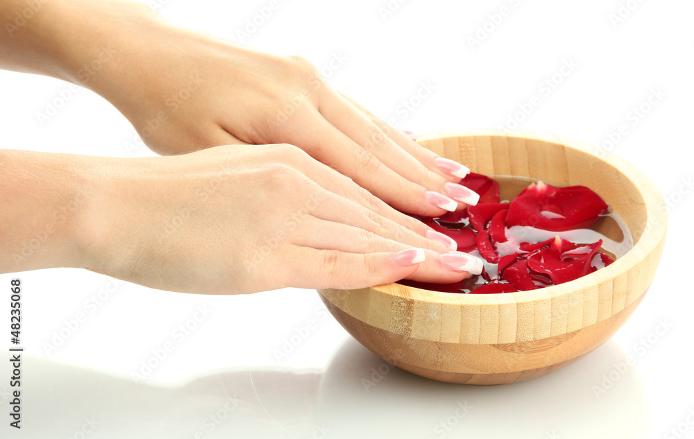 woman hands with wooden bowl of water with petals, isolated woman hands with wooden bowl of water with petals, isolated