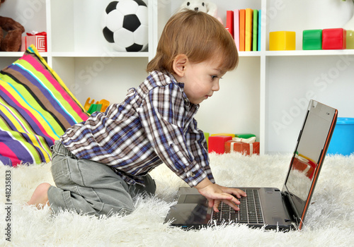 cute little boy and noteboo...
