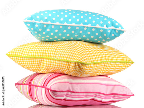 Blue, pink and yellow bright pillows isolated on white © Africa Studio