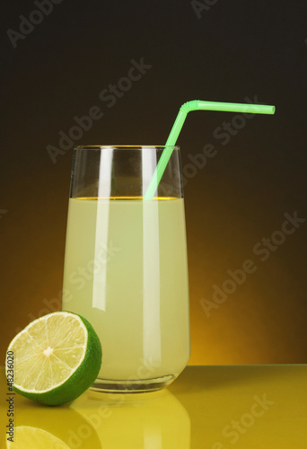 Delicious lemon juice in glass and lime next to it