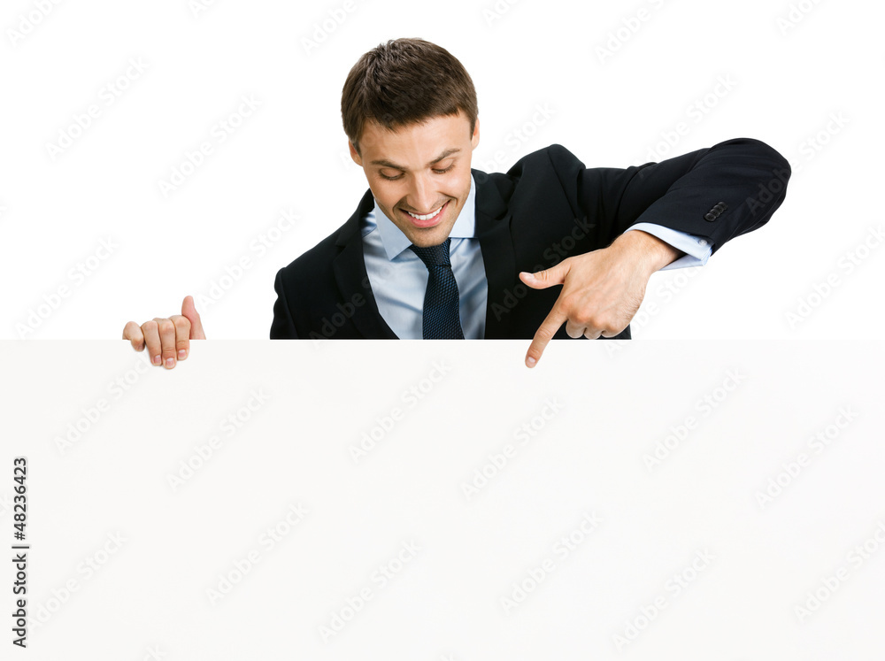 Happy businessman showing signboard, isolated Happy businessman showing signboard, isolated