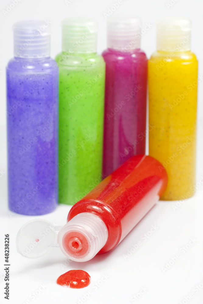 Bath set colorful peeling bottle closeup on white background Bath set colorful peeling bottle closeup on white background