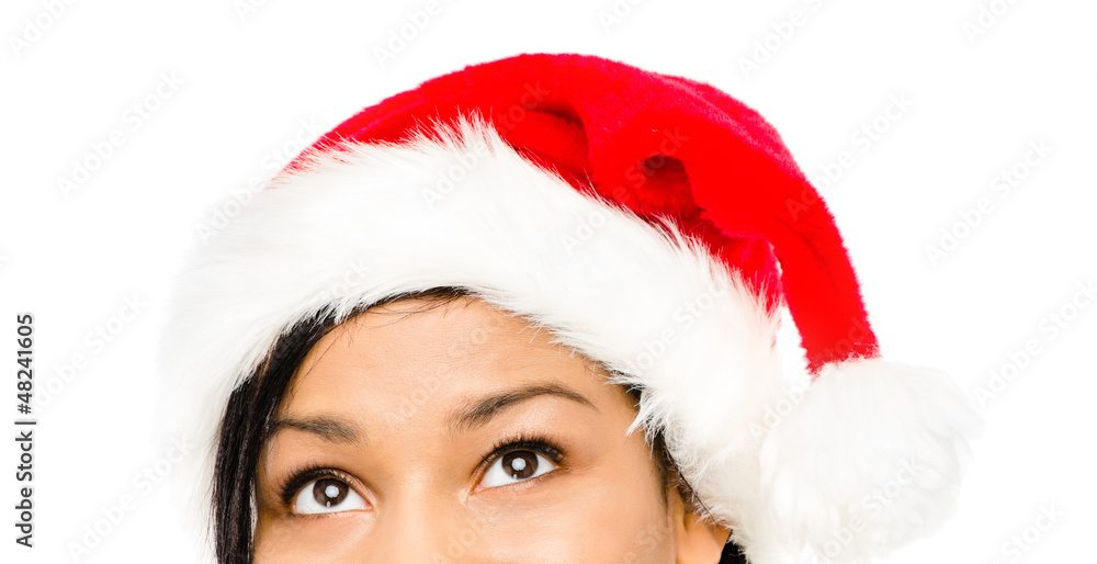 Close up of pretty woman wearing christmas hat looking up isolat Close up of pretty woman wearing christmas hat looking up isolat