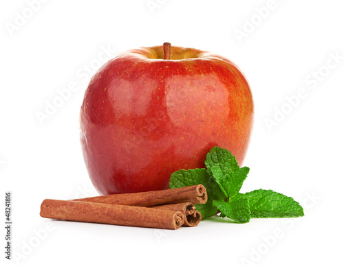 Red apple, cinnamon sticks and mint leaves