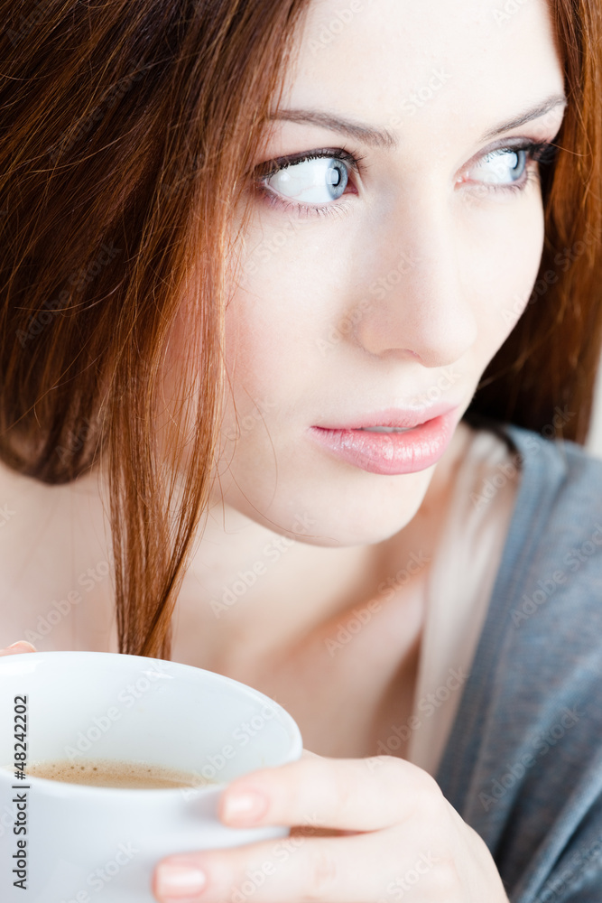 Pensive lady with cup of tea has a rest at the cafe Pensive lady with cup of tea has a rest at the cafe