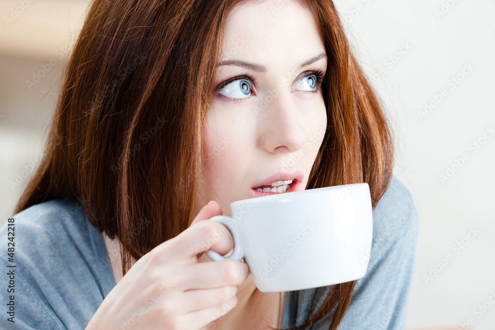 Woman with cup of tea has a rest at the bar Woman with cup of tea has a rest at the bar