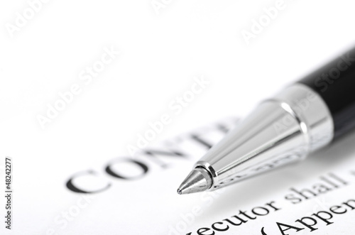 Close-up of silver pen on contract.