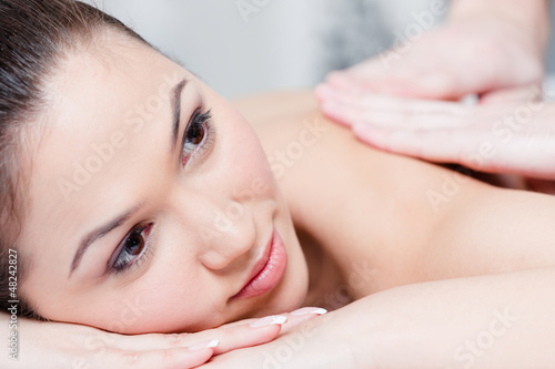 Beautiful woman relaxing in massage salon. Health procedure