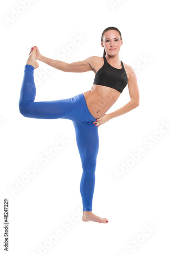 Sexy young yoga woman doing yogic exercise on isolated
