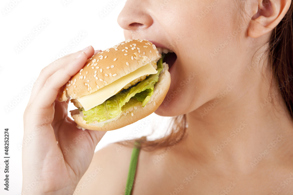 Young attractive woman eating hamburger Young attractive woman eating hamburger