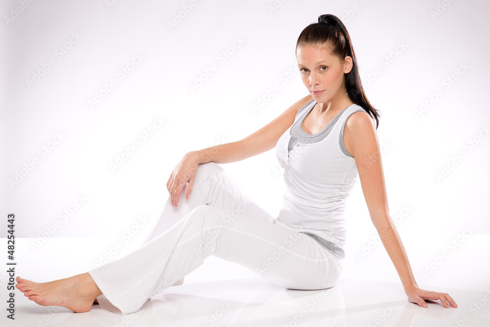 Woman relaxing during training on white background Woman relaxing during training on white background