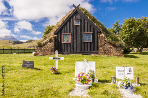 View on graveyard and Vidimyri church - Iceland. photo