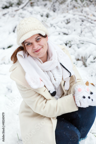 Young woman having fun with snow on winter day