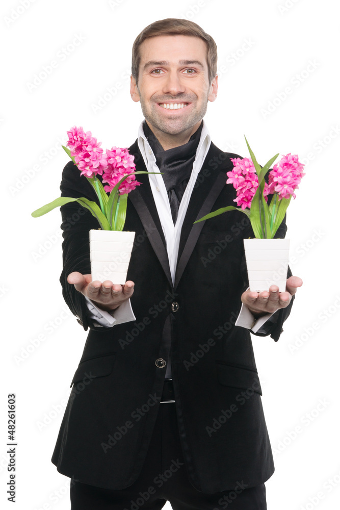 Handsome stylysh man presenting flowers Handsome stylysh man presenting flowers