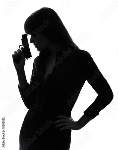 Fotografie sexy detective  woman holding aiming  gun silhouette