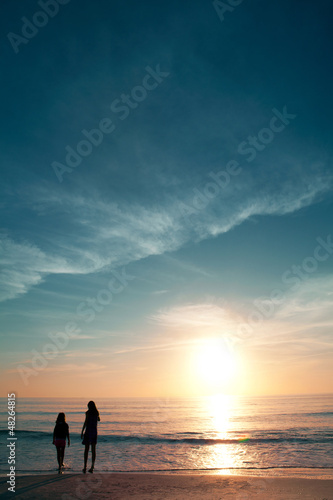 Girls on beautiful beach during sunset. © Mirma