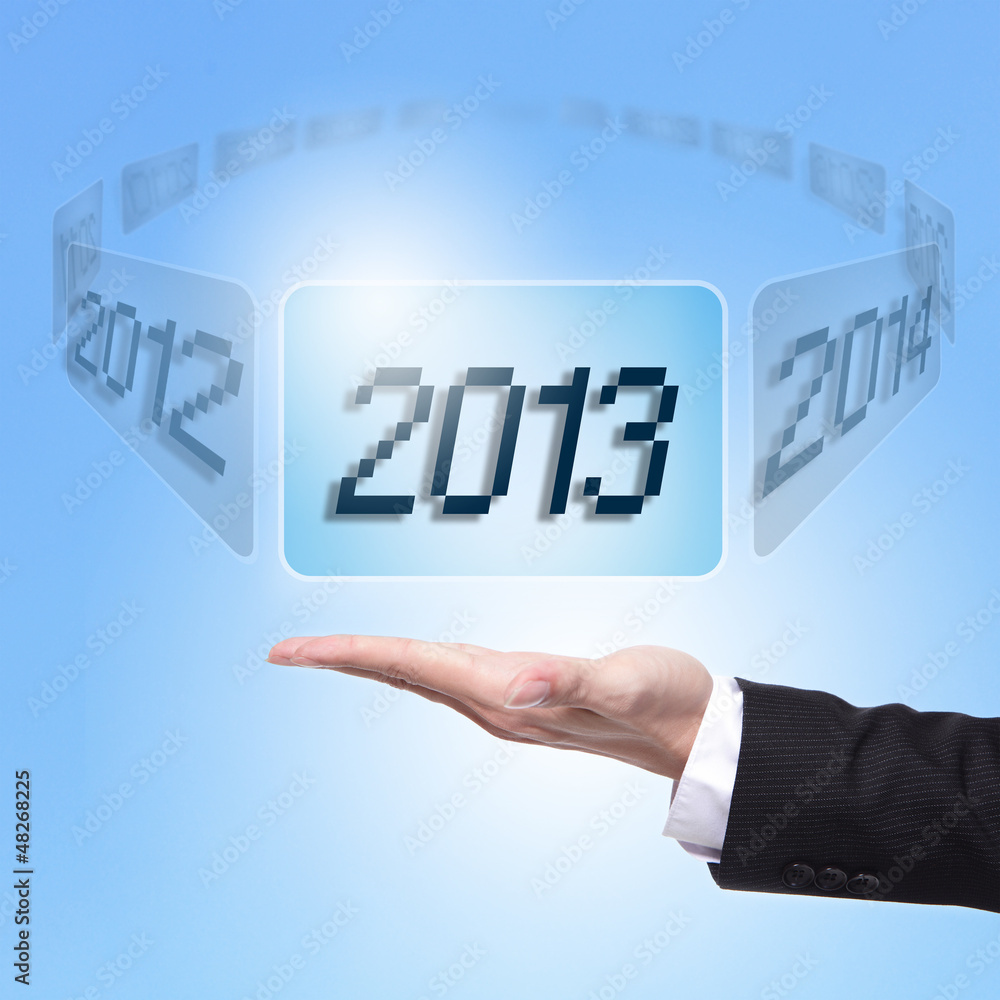 © ryanking999 - Business man holding screen with 2013
