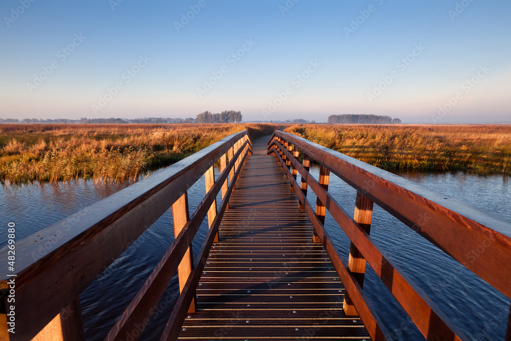 wooden bridge through canal