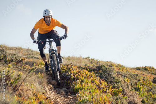 Mountain biker riding dirt trail