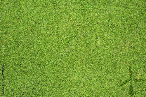 Wind turbine icon on green grass background