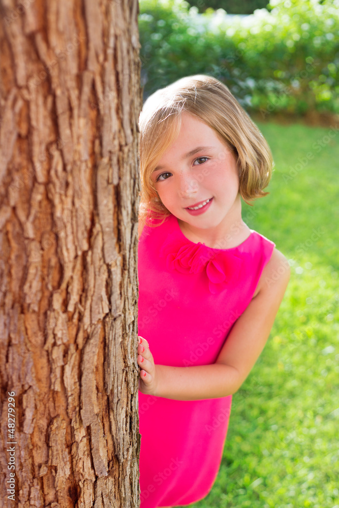 child happy girl smiling rear tree trunk in garden child happy girl smiling rear tree trunk in garden