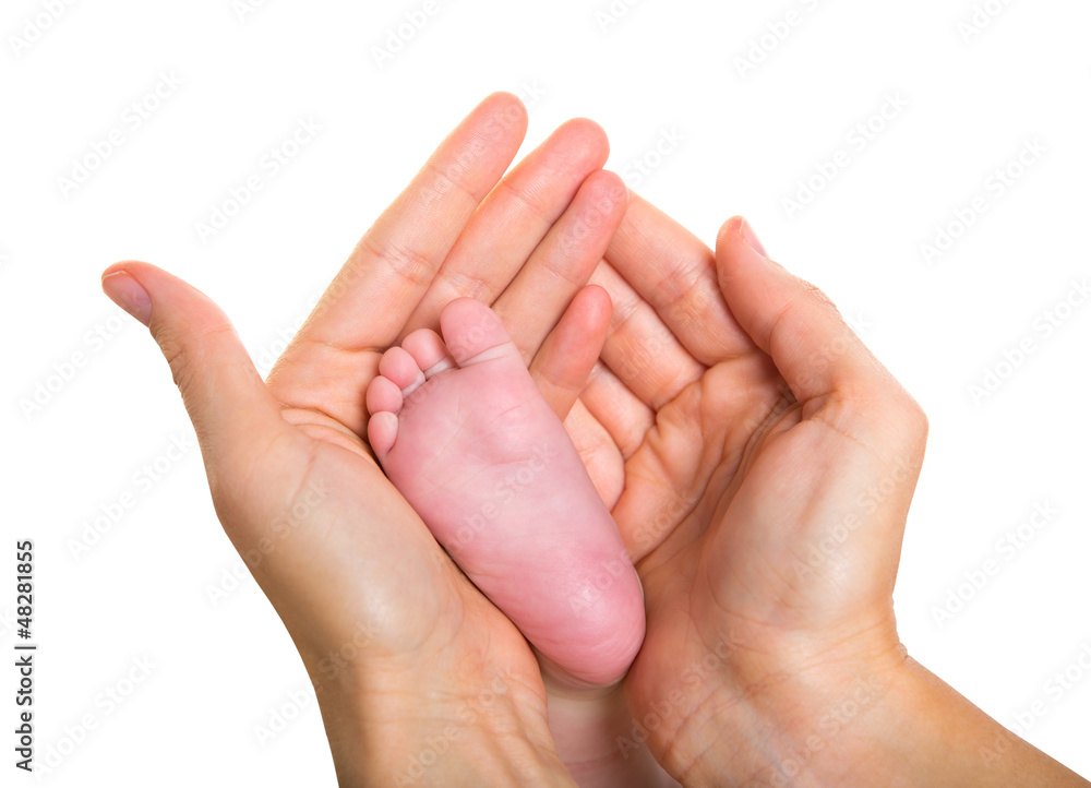 Mother hands holding baby nude feet on white Mother hands holding baby nude feet on white