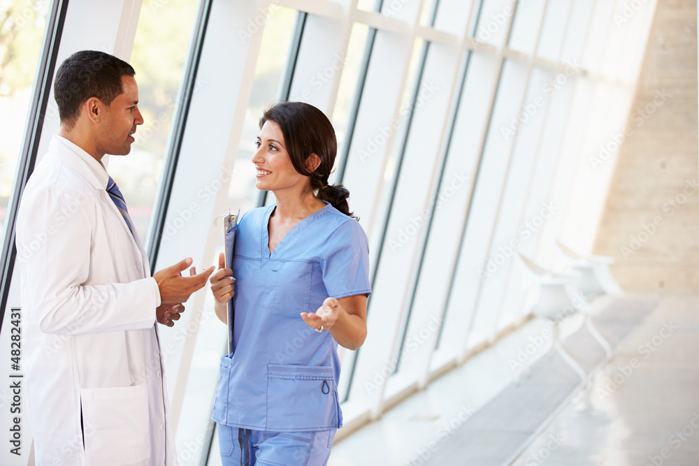Medical Staff Having Discussion In Modern Hospital Corridor Medical Staff Having Discussion In Modern Hospital Corridor