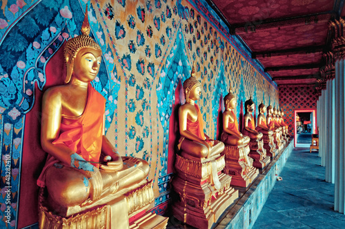 golden statues of Buddha in Wat Arun temple, Bangkok
