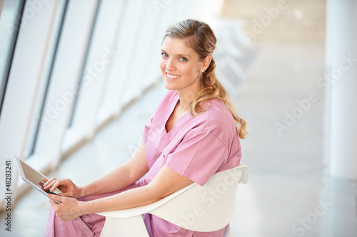 Female Nurse Sitting In Chair Using Digital Tablet Free Download Female Nurse Sitting In Chair Using Digital Tablet - GFXLoad