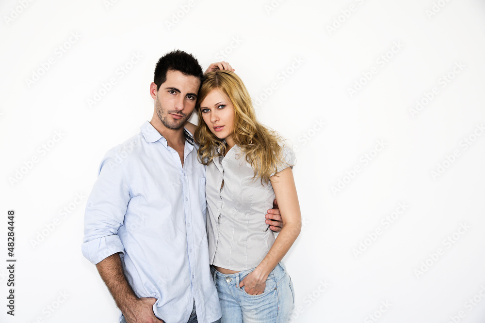 Fototapeta premium Trendy young couple standing on white background