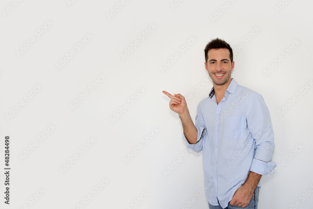 Cheerful young man showing message on whiteboard Cheerful young man showing message on whiteboard