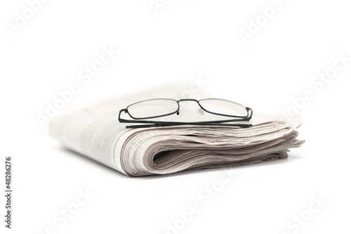 glasses on folded newspaper