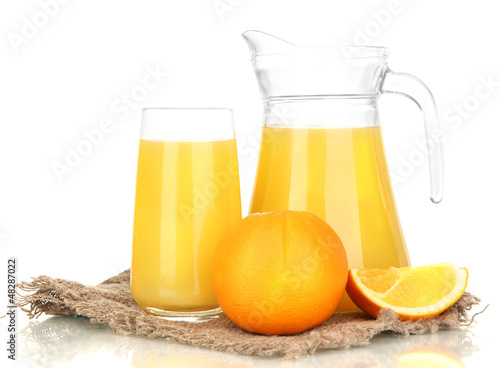 Full glass and jug of orange juice and oranges isolated on