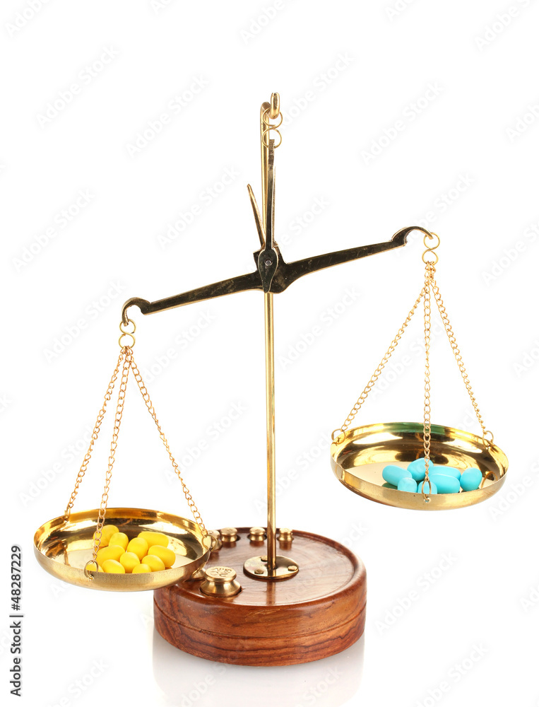 Classic scales with color pills isolated on white Classic scales with color pills isolated on white