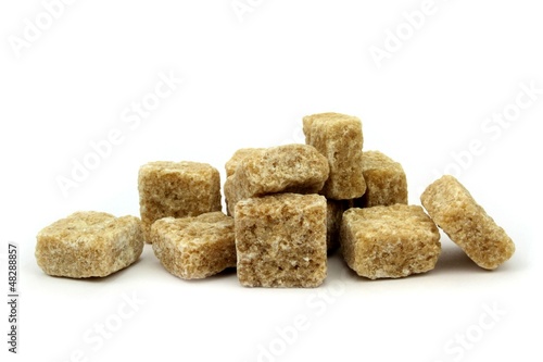 Brown cane sugar cubes isolated on white background