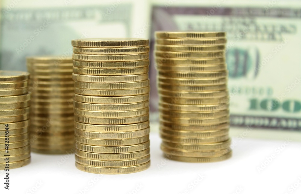 Stacked coins, euro and dollar banknotes Stacked coins, euro and dollar banknotes