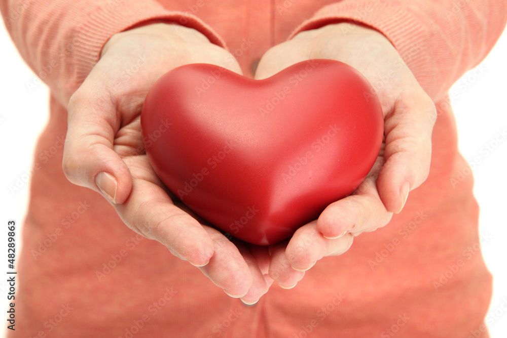 Red heart in woman hands, close up Red heart in woman hands, close up