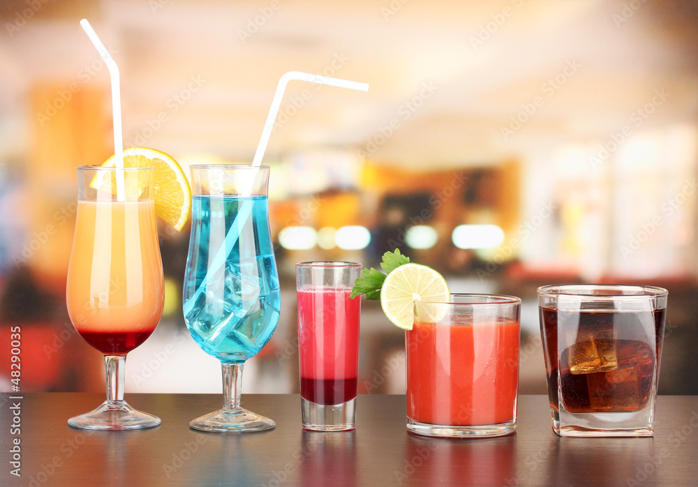 Several glasses of different drinks on bright background Several glasses of different drinks on bright background
