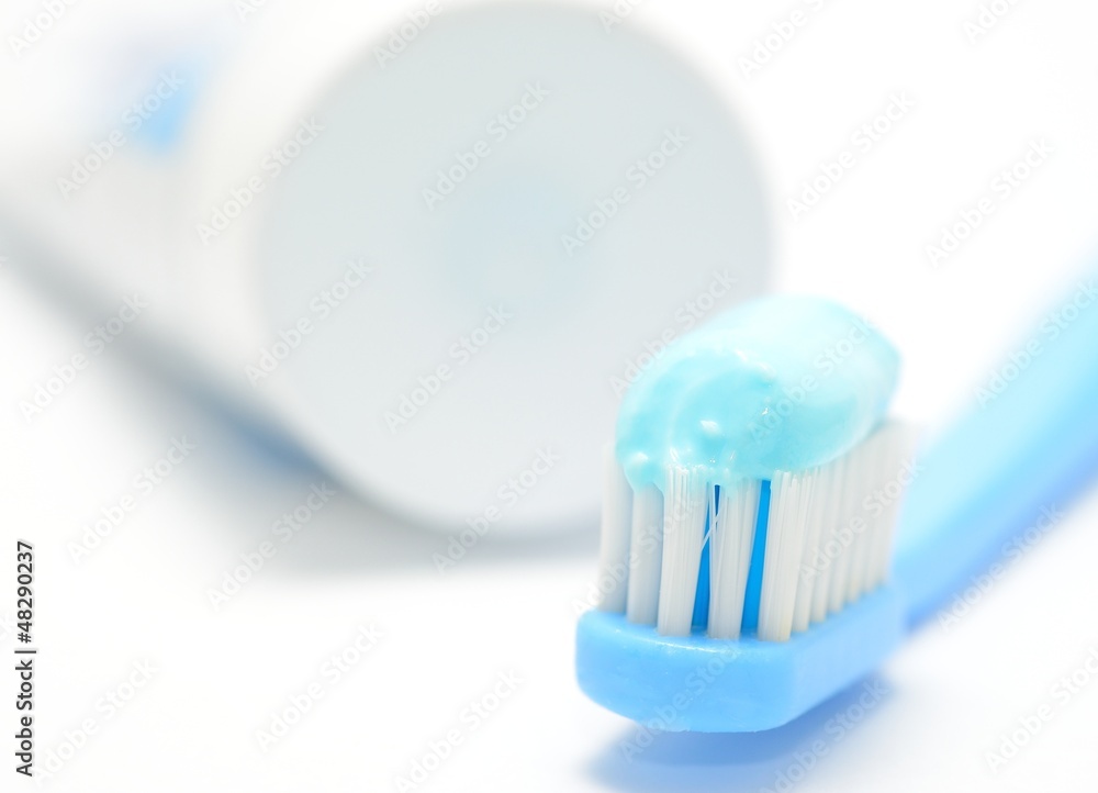 Macro shot of toothbrush and toothpaste on the white background.