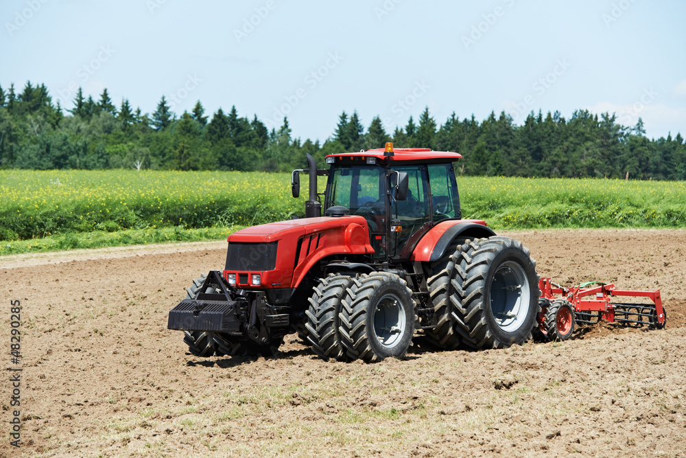 Ploughing tractor at field cultivation work Ploughing tractor at field cultivation work